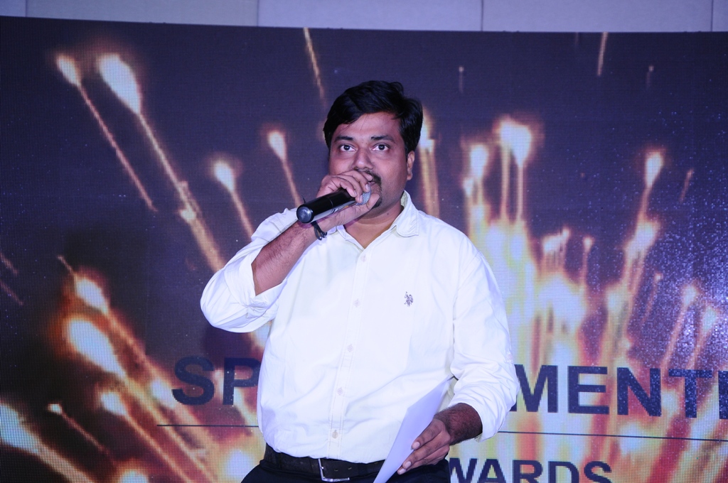 Pranjal Chawan speaking on stage at an awards event